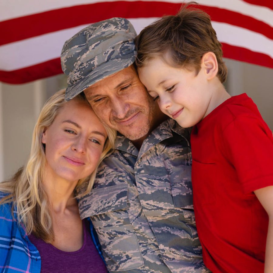 Caucasian family with military man standing entrance of house. family, love and patriotism concept, unaltered.